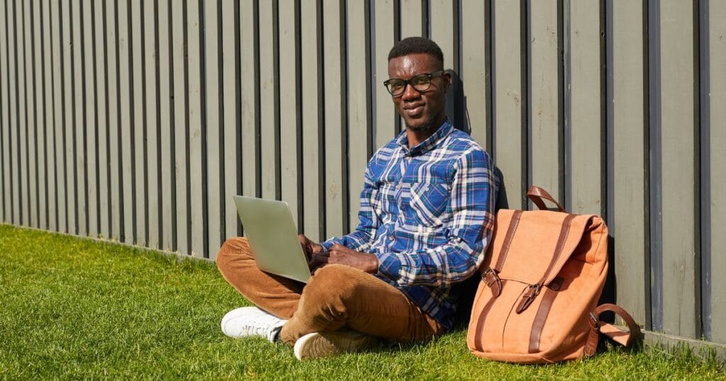 Kenyan university student studying online on laptop