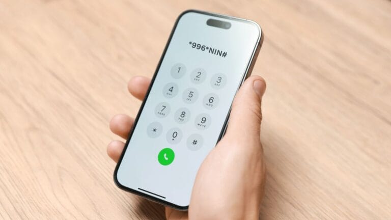 Hand dialing 996# on a smartphone to link a NIN to an Airtel line in Nigeria.