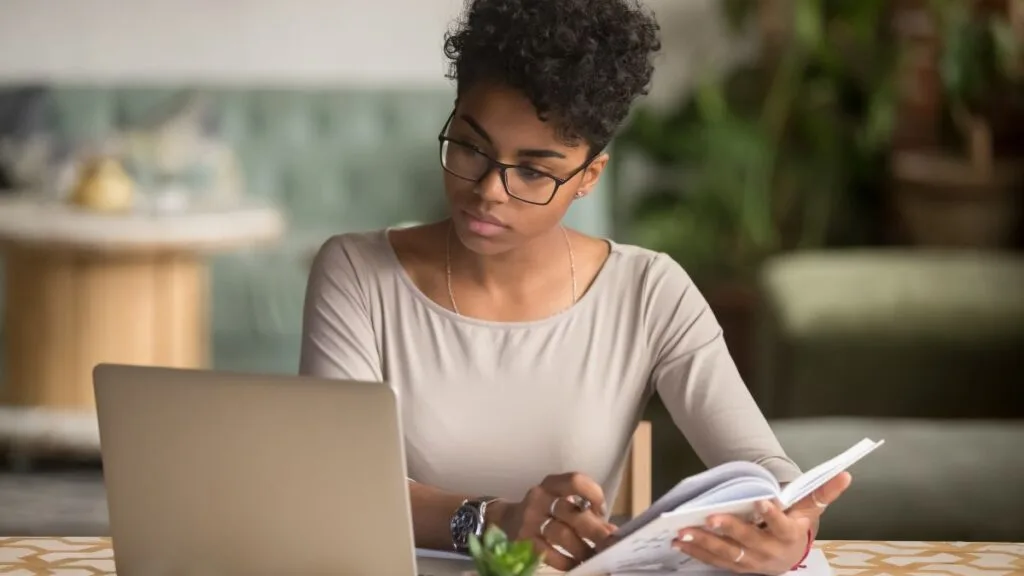 South African student using a laptop at home to prepare documents for an NSFAS appeal
