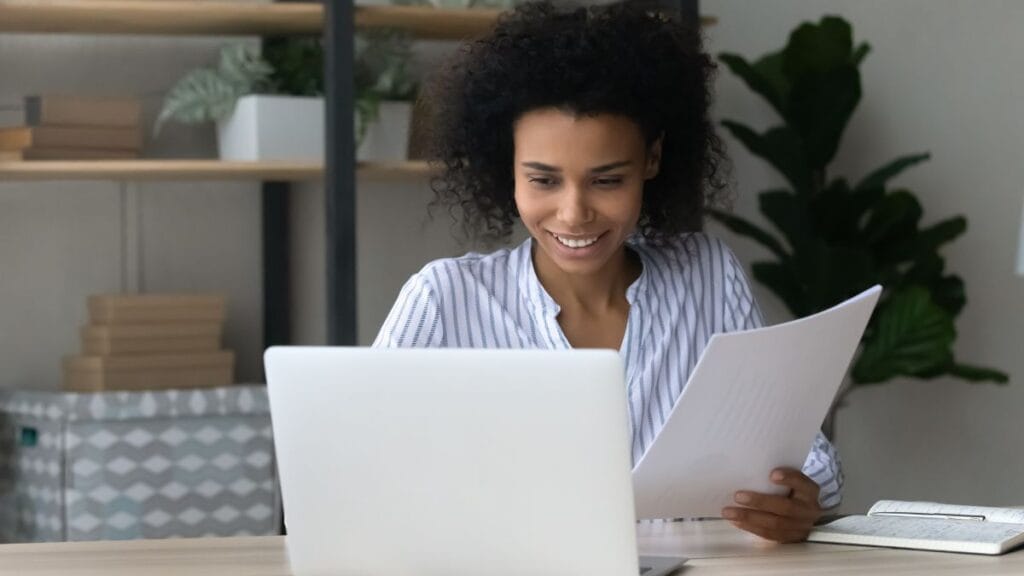 South African student checking NSFAS funding stages on the myNSFAS portal using a laptop at home.