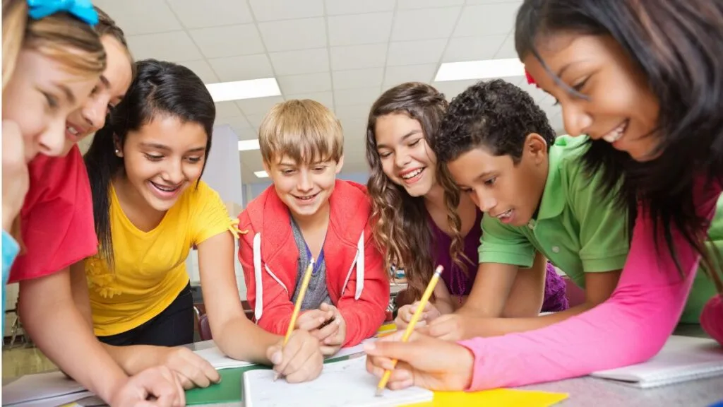 Upper primary students sitting together and working on a group activity during a social studies lesson.