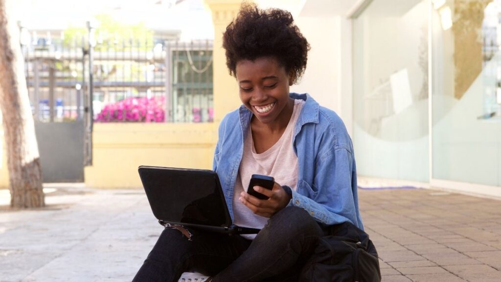 student checking her mobile if NSFAS provisionally funded her