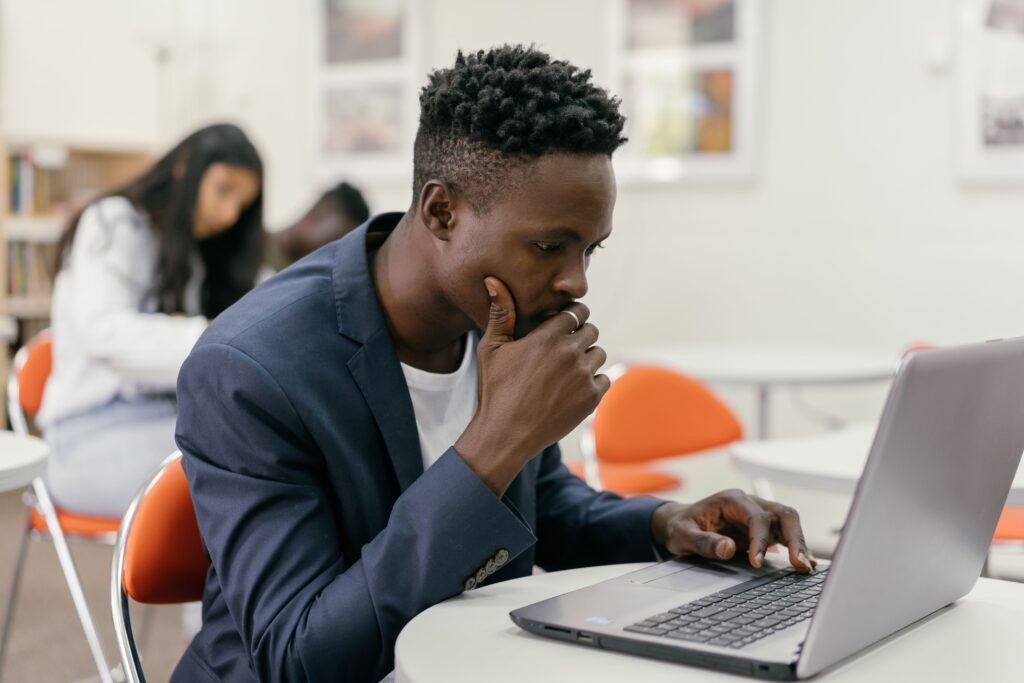 Student thinking while using laptop